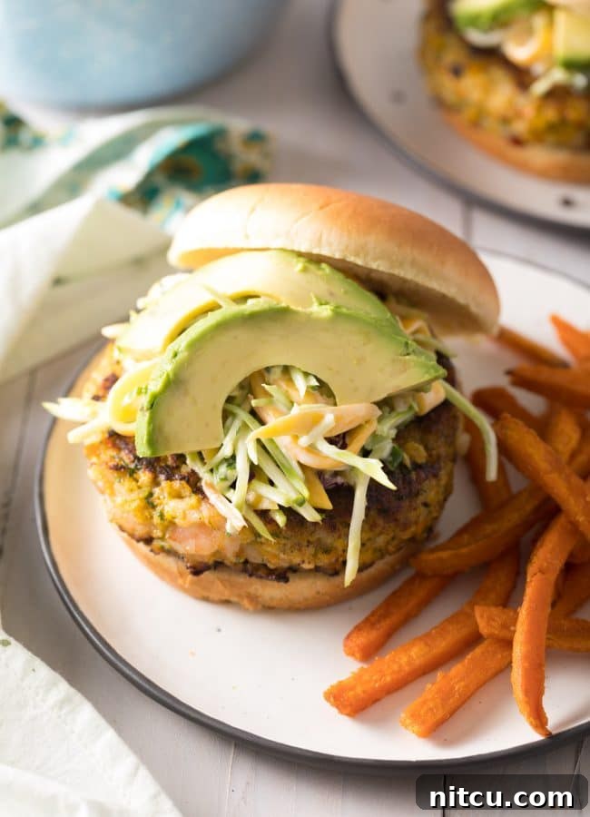 Shrimp Burger Recipe on plate with avocado and slaw – a delicious Caribbean-inspired meal