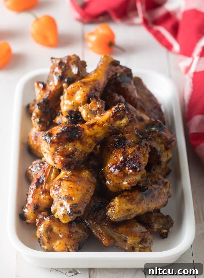 White rectangle dish loaded with grilled habanero peach chicken wings.