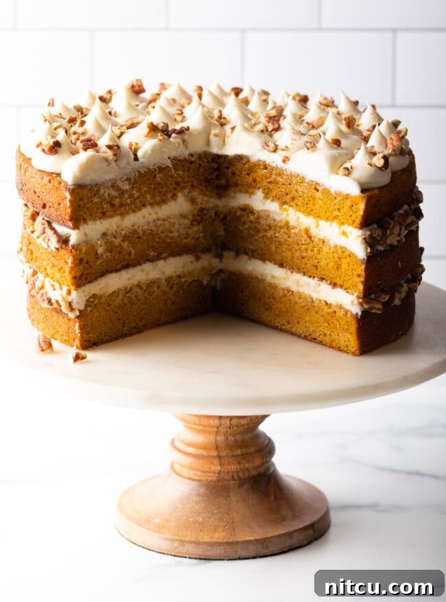 Sliced spiced pumpkin cake on a stand. 