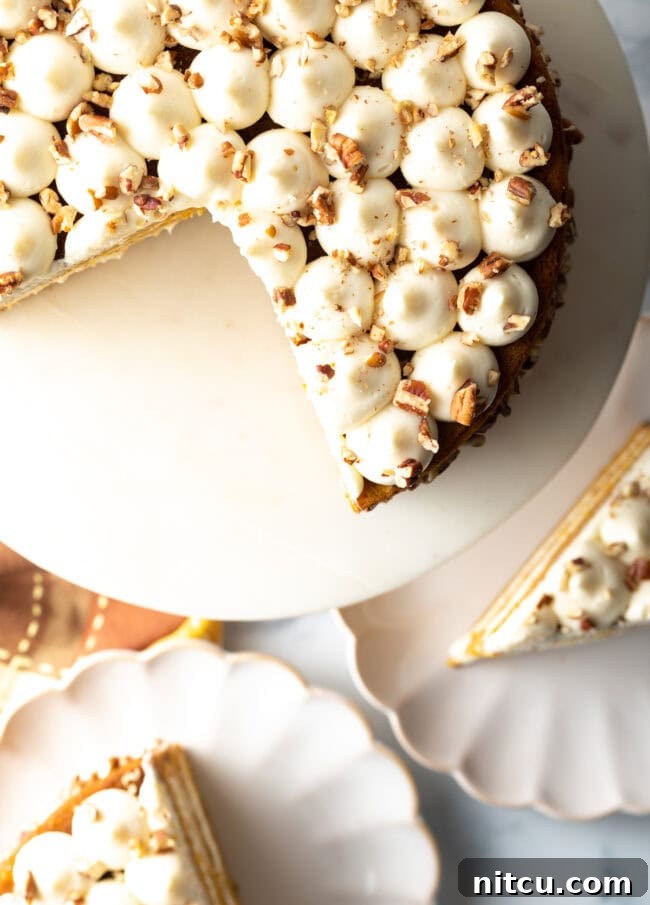 Overhead shot of frosted cake with a piece missing. 