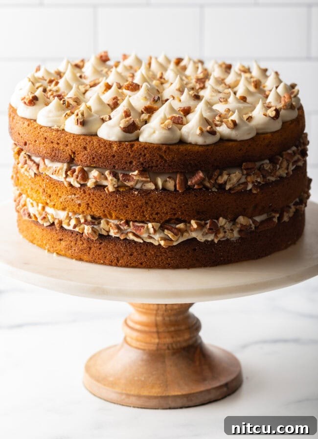 Spiced Pumpkin Cake with Spice Cake Frosting on cake stand.