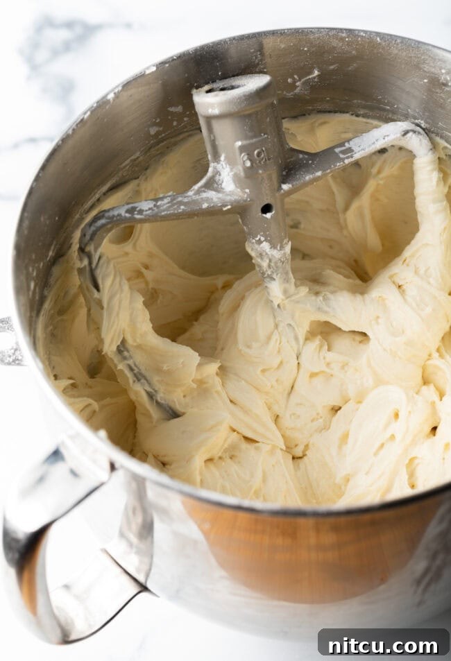 Maple frosting being mixed in a mixer. 
