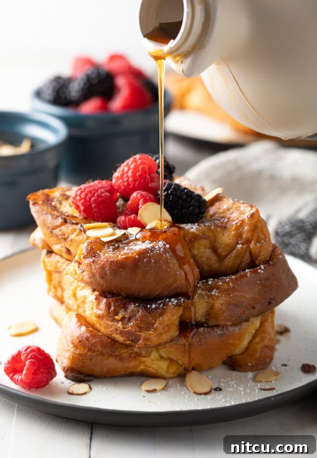 How To Make Pain Perdu - toast piled high on a white plate.