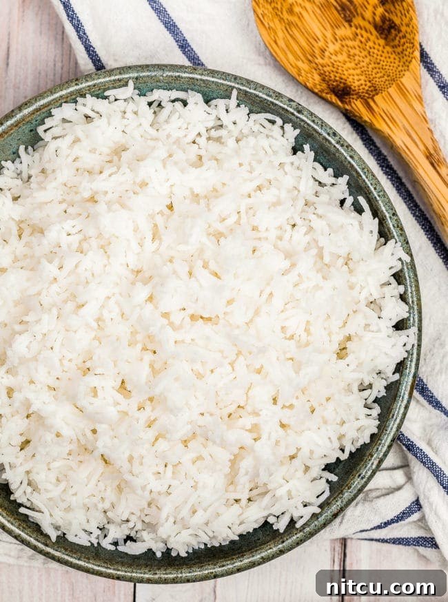 A top down view of basmati rice in a gray bowl.