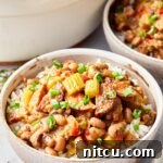 Flavorful Hoppin' John with black-eyed peas, sausage, and vegetables in a bowl.