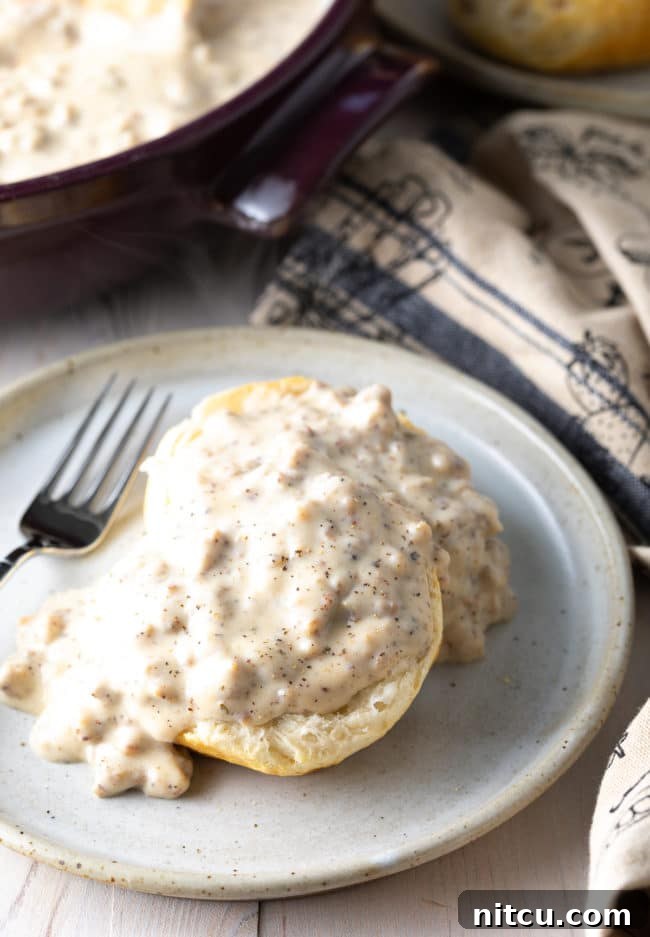 fluffy cathead biscuits covered in white sausage gravy