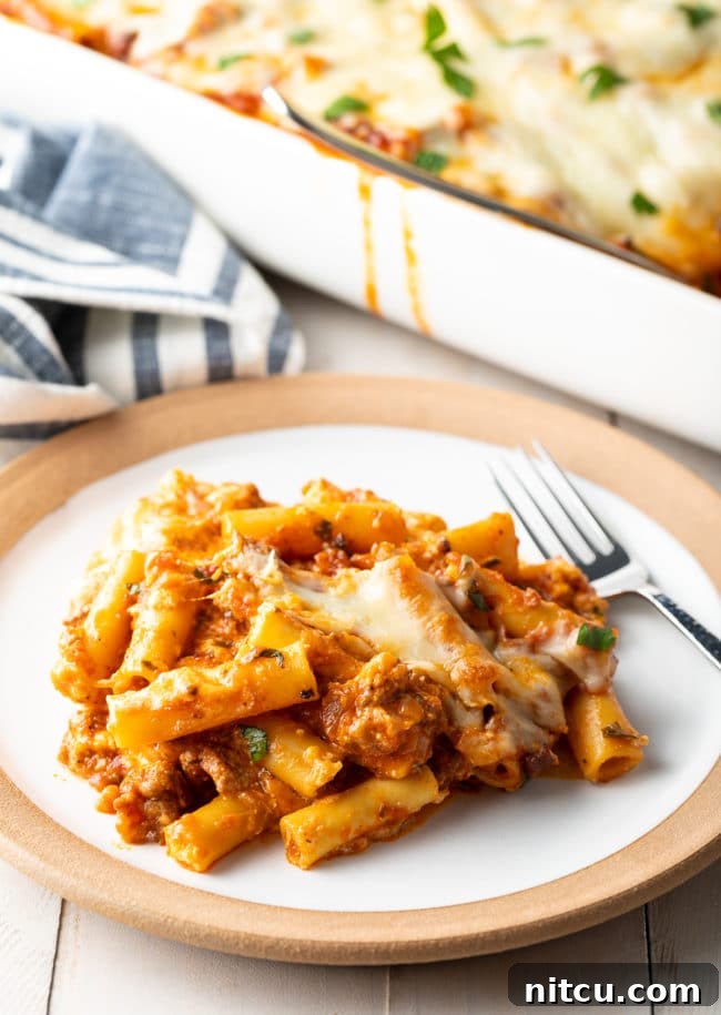 Close-up of baked ziti with Italian sausage and ricotta on a plate, ready to eat