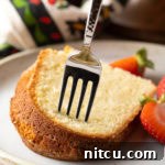 A beautifully baked Classic Cream Cheese Pound Cake, golden and inviting, ready for slicing.