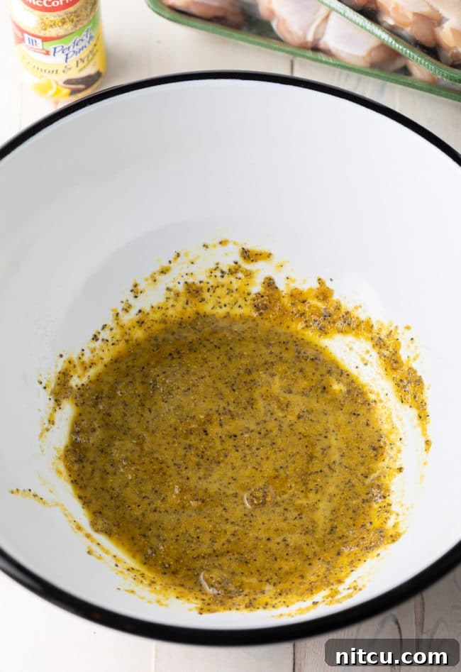 Lemon Pepper rub being applied to chicken wings