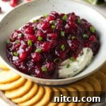 Cranberry Jalapeno Cream Cheese Dip, a sweet, spicy, and creamy holiday appetizer perfect for any party.