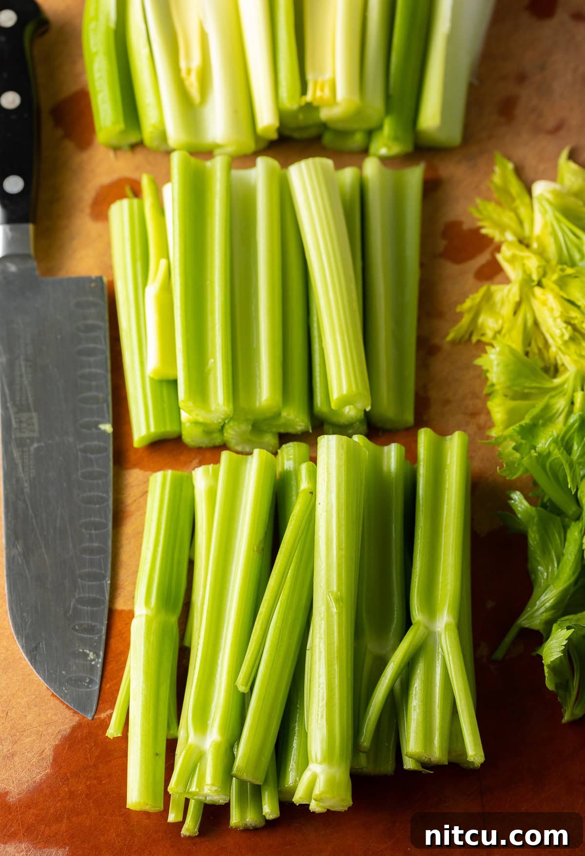 Washed and trimmed celery stalks on a cutting board. 