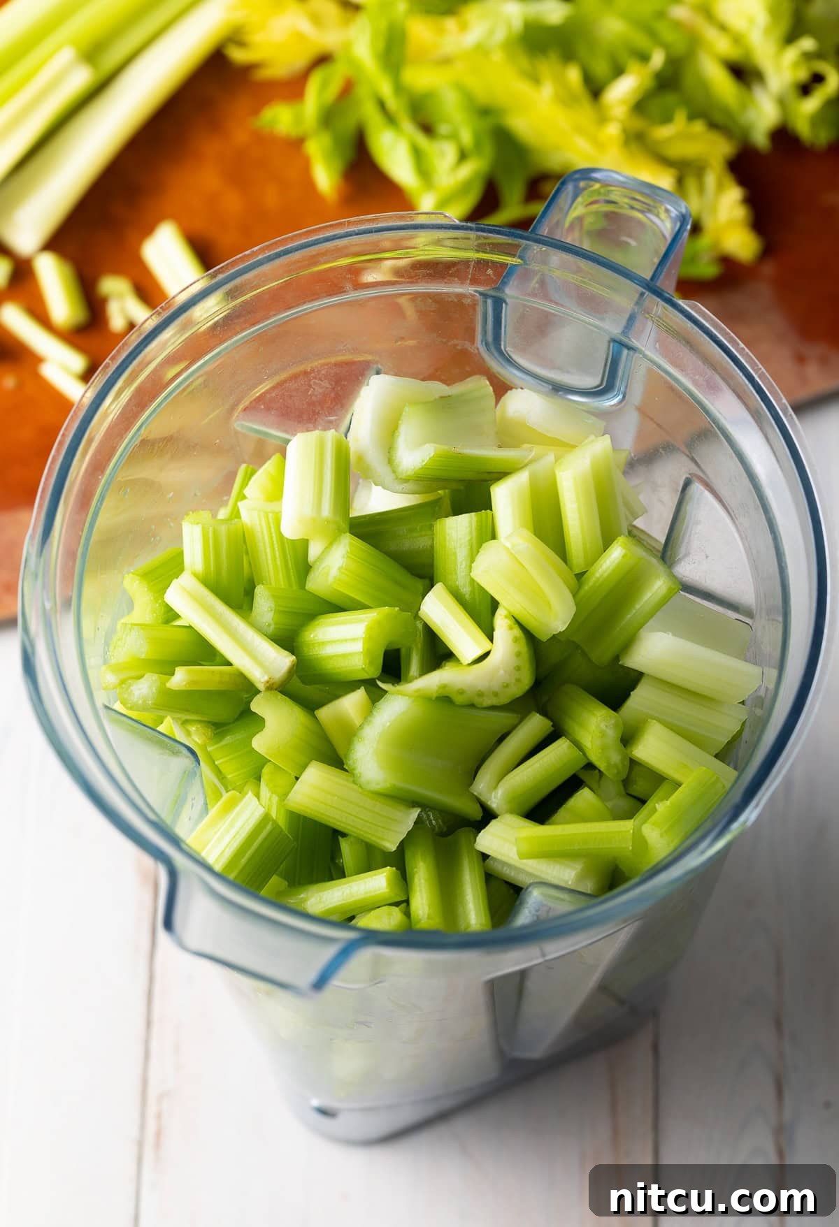 Chopped celery in a blender. 