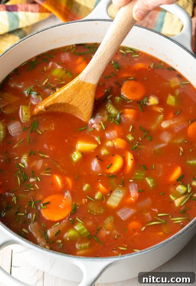 Tuscan Lentil Soup simmering on the stovetop, a comforting and flavorful vegetarian dish.