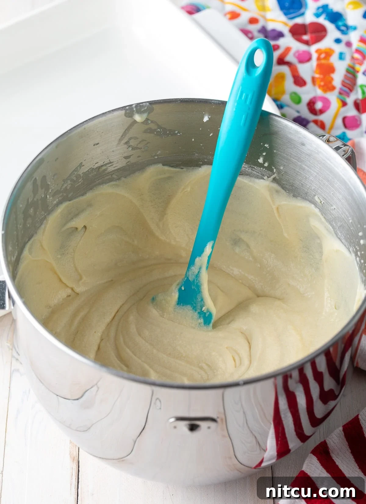 Smooth cake batter perfectly mixed in a stand mixer bowl.