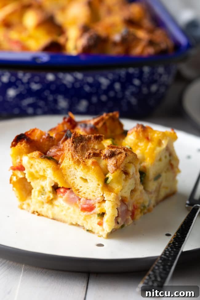 egg strata - cut on plate with fillings poking out of fluffy layers