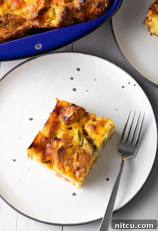 make ahead breakfast (overnight breakfast casserole) cut into pieces and served on black and white plates