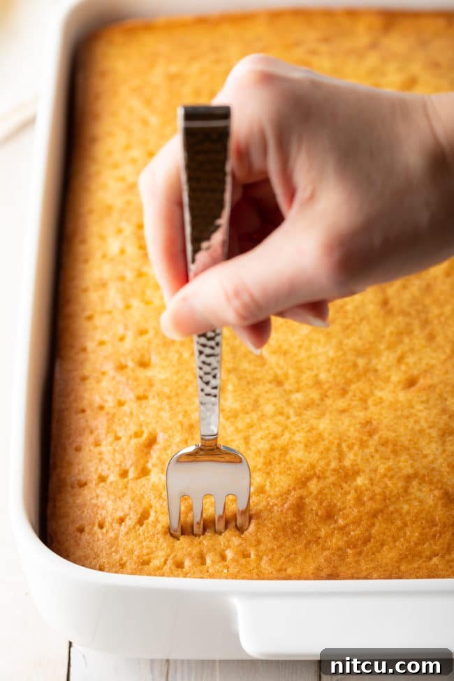 Visual guide for preparing Poke Cake, illustrating the cake batter in the pan before baking.