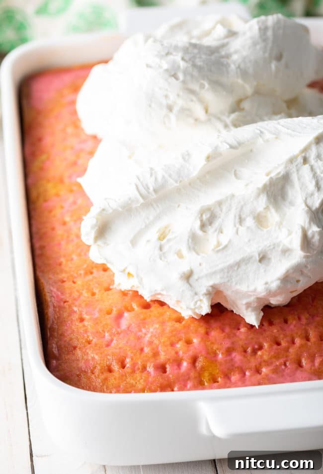Strawberry-Coconut Jello Cake Recipe in progress, showing the golden baked cake.