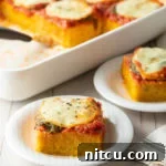 Margherita Baked Polenta: An Easy, Cheesy Polenta Recipe layered with marinara sauce, fresh basil, and mozzarella cheese, all on a comforting Pesto Polenta base!