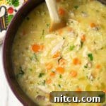 Creamy Parmesan Chicken and Rice Soup, close-up in a bowl.
