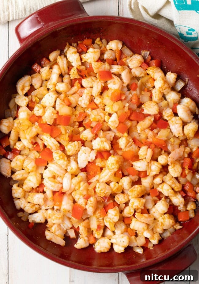 Hot shrimp dip - shrimp and other ingredients mixed together in a making dish. 