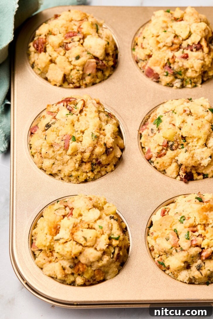 Muffin pans filled with unbaked stuffing mixture, showcasing the preparation before going into the oven