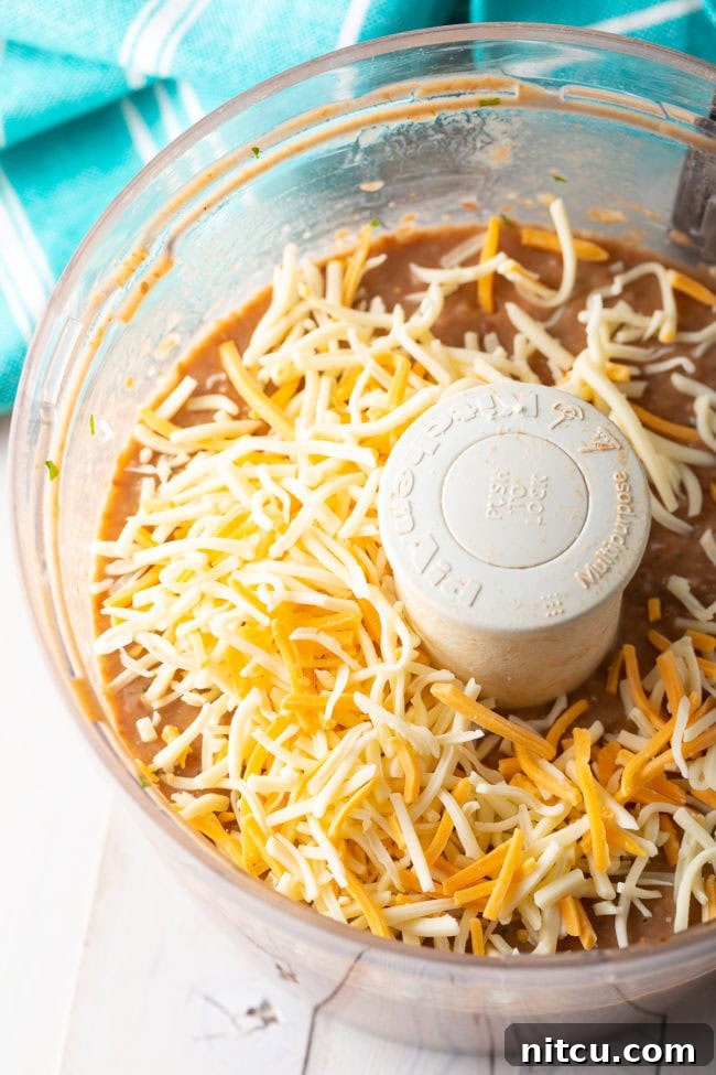 Creamy bean dip in a food processor, after being blended to the perfect consistency.