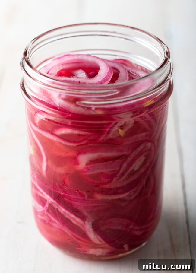 How to Pickle Red Onions - close up of jar with onions