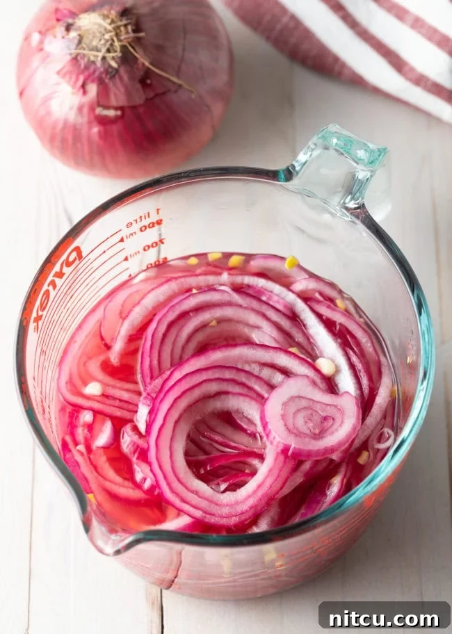 quick pickled red onions in measuring pitcher