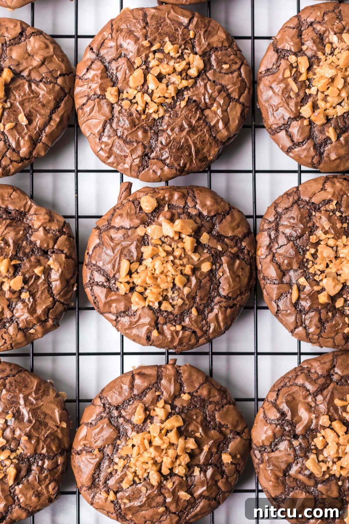 Soft Brownie Cookies with Toffee Bits on cooling rack