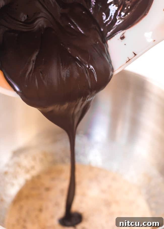 pouring chocolate into the cookie dough