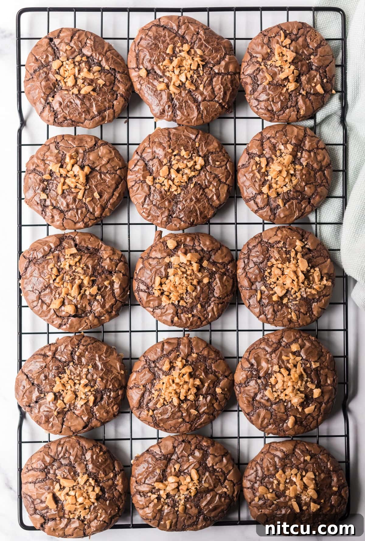 Toffee Brownie Cookies on cooling rack with toffee bits on top