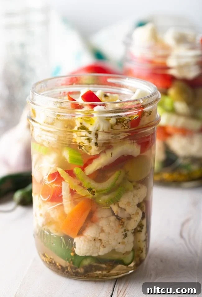 A beautifully arranged jar of homemade Italian pickled vegetables, showcasing the colorful mix.