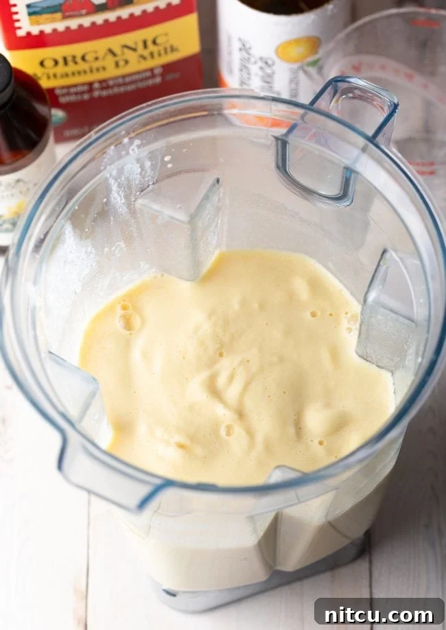 Orange Julius smoothie in the blender after being perfectly blended to a frothy consistency.