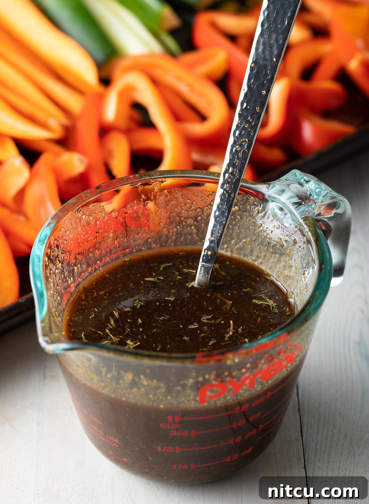 Mixing the grilled vegetable marinade ingredients in a small pitcher until smooth.