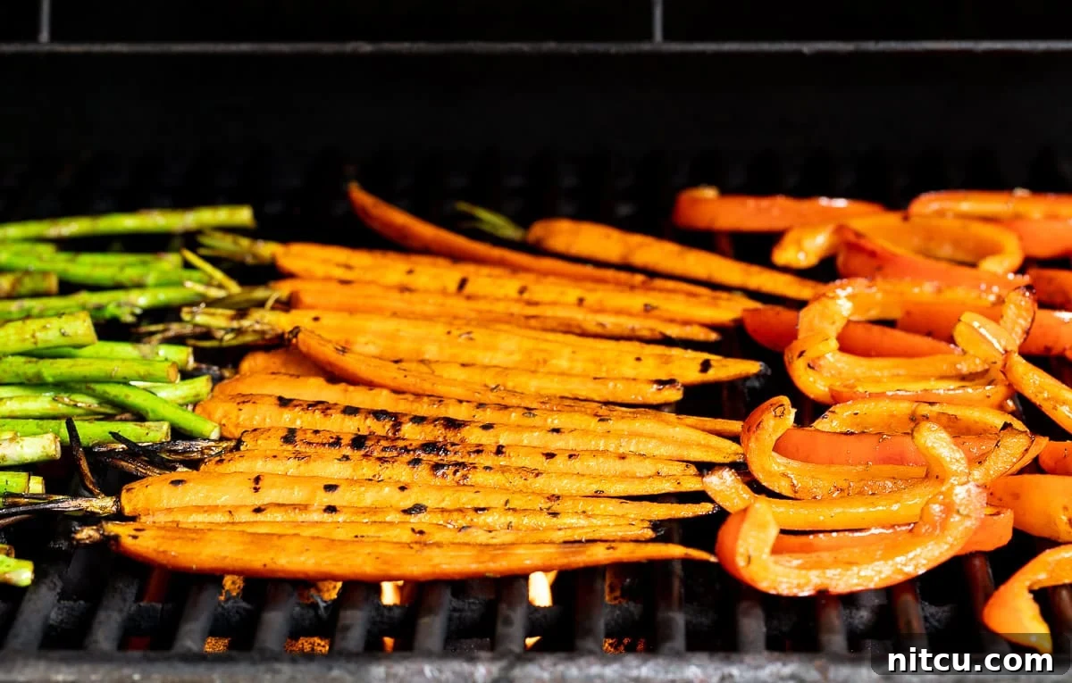 Marinated vegetables sizzling on a hot grill, showing smoky char marks and vibrant colors.
