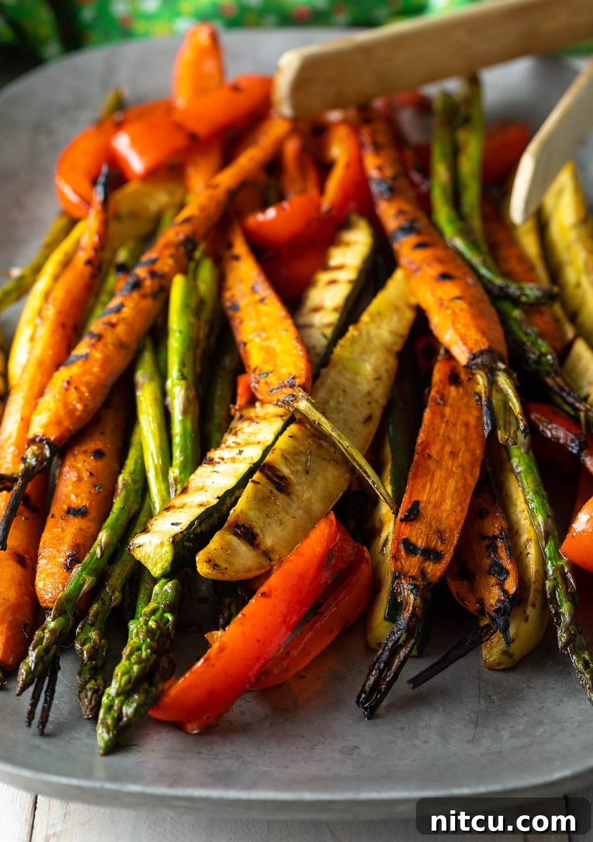 Close-up of a large serving platter filled with colorful summer marinated grilled vegetables, ready to be served.