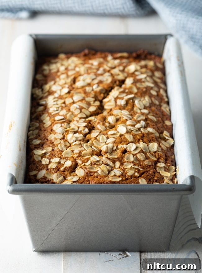The golden-brown, beautifully baked banana oatmeal bread, freshly out of the oven.