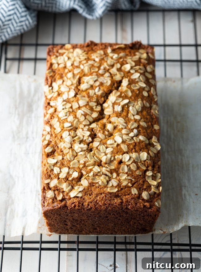 Freshly baked loaf of banana bread cooling on a wire rack.