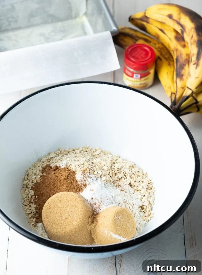 Dry ingredients for banana bread added into a mixing bowl.
