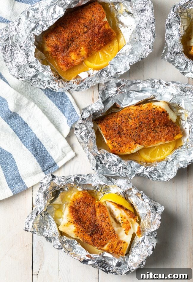 Close-up of lemon pepper seasoned fish fillets ready for grilling in foil.