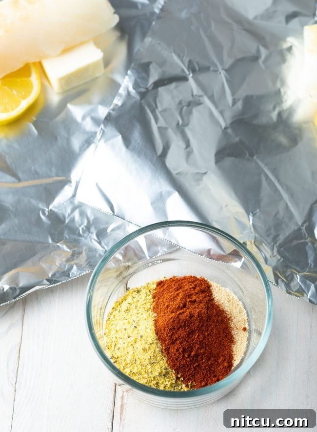 A small bowl containing a vibrant lemon pepper spice blend with garlic powder and smoked paprika.