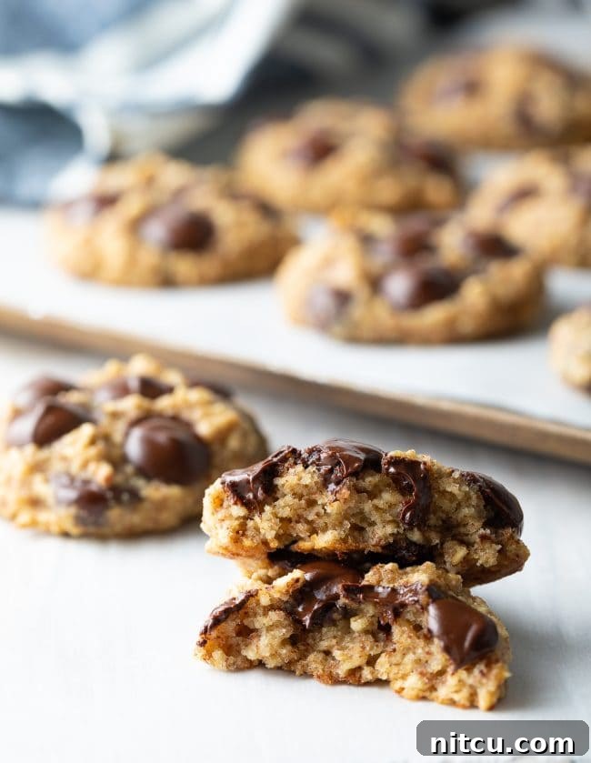Banana oat cookie broken in half and stacked on top of each other. 