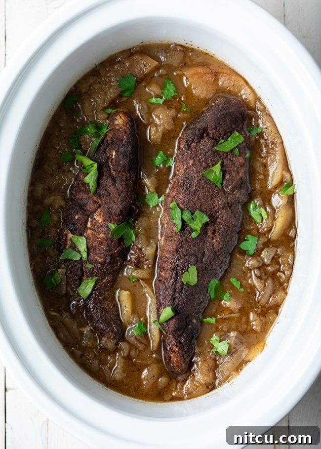 Pork tenderloins in an apple and onion sauce in the crockpot.