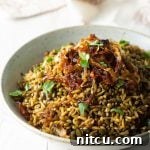 A delicious serving of Mujadara, showcasing the lentils, rice, and crispy onions.