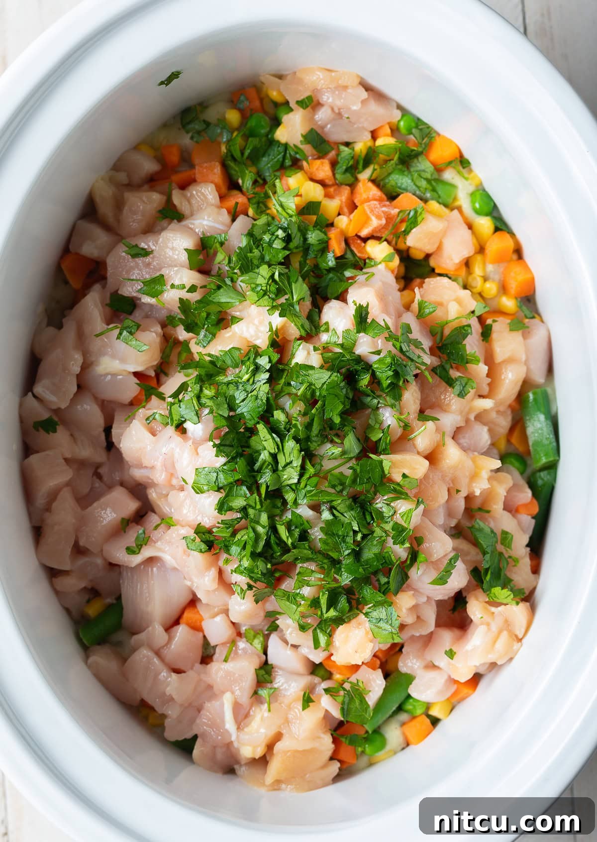 All ingredients for chicken pot pie in the crockpot.