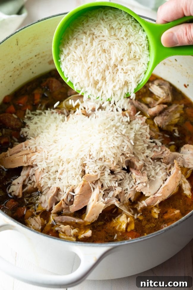 adding rice to chicken bog