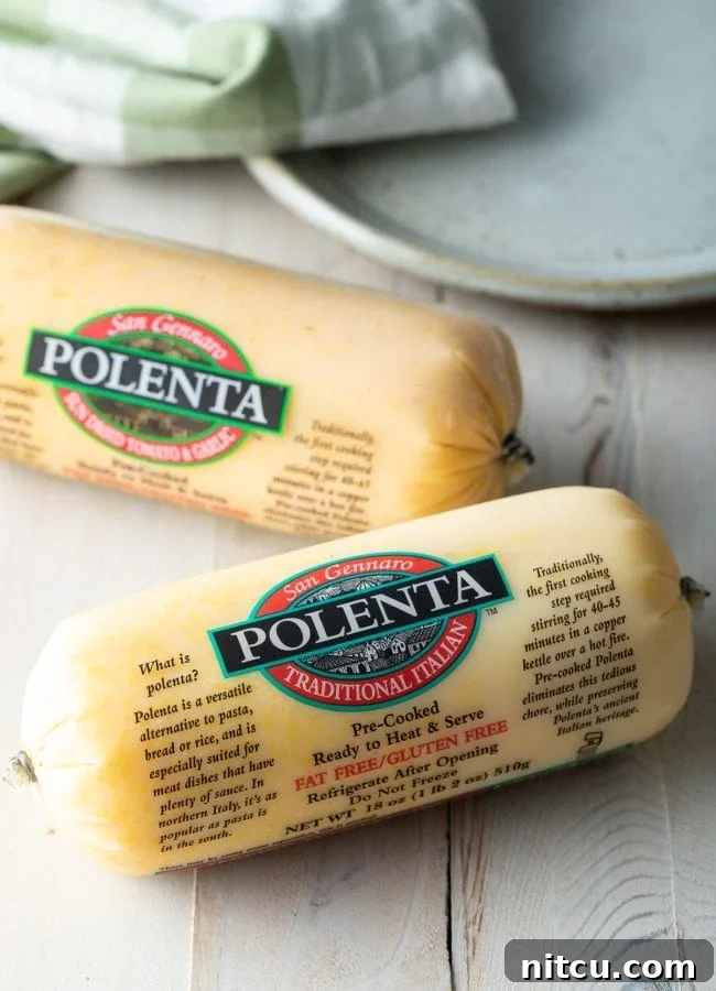 Two polenta logs before being sliced, showing their smooth, firm texture.
