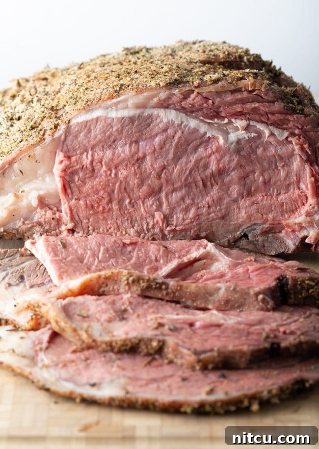 Traeger smoked prime rib au jus recipe with slices displayed on a cutting board