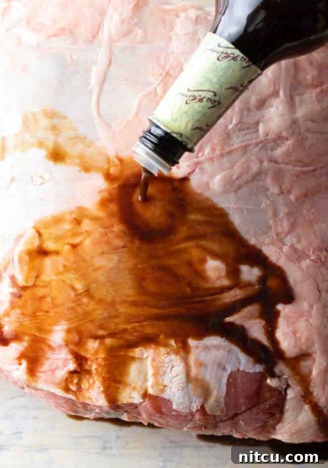 Adding Worcestershire sauce to a prime rib roast before seasoning